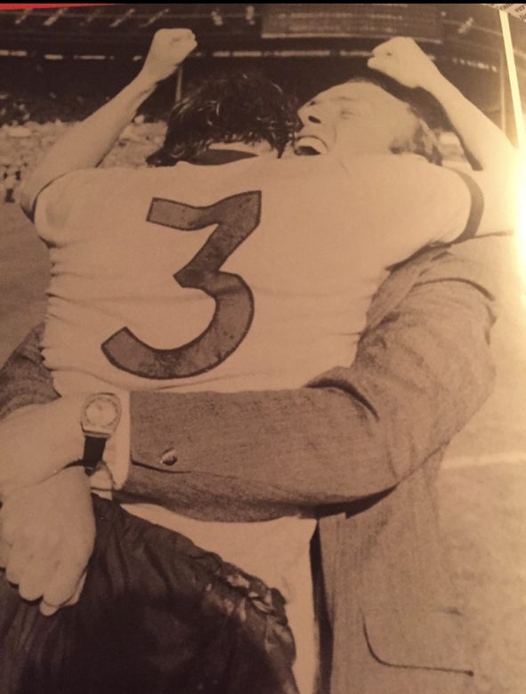 We've done it! Bob and Don Howe embrace after completing the Double